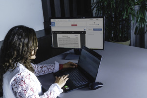 Woman at office desk using notebook