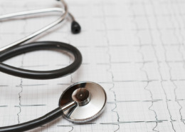 estetoscópio apoiado em cima de exame de ECG