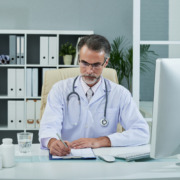 médico em consultório assinando documento