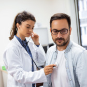 médica avaliando paciente em consultório