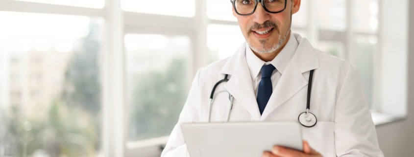 médico em pé em corredor de área hospitalar